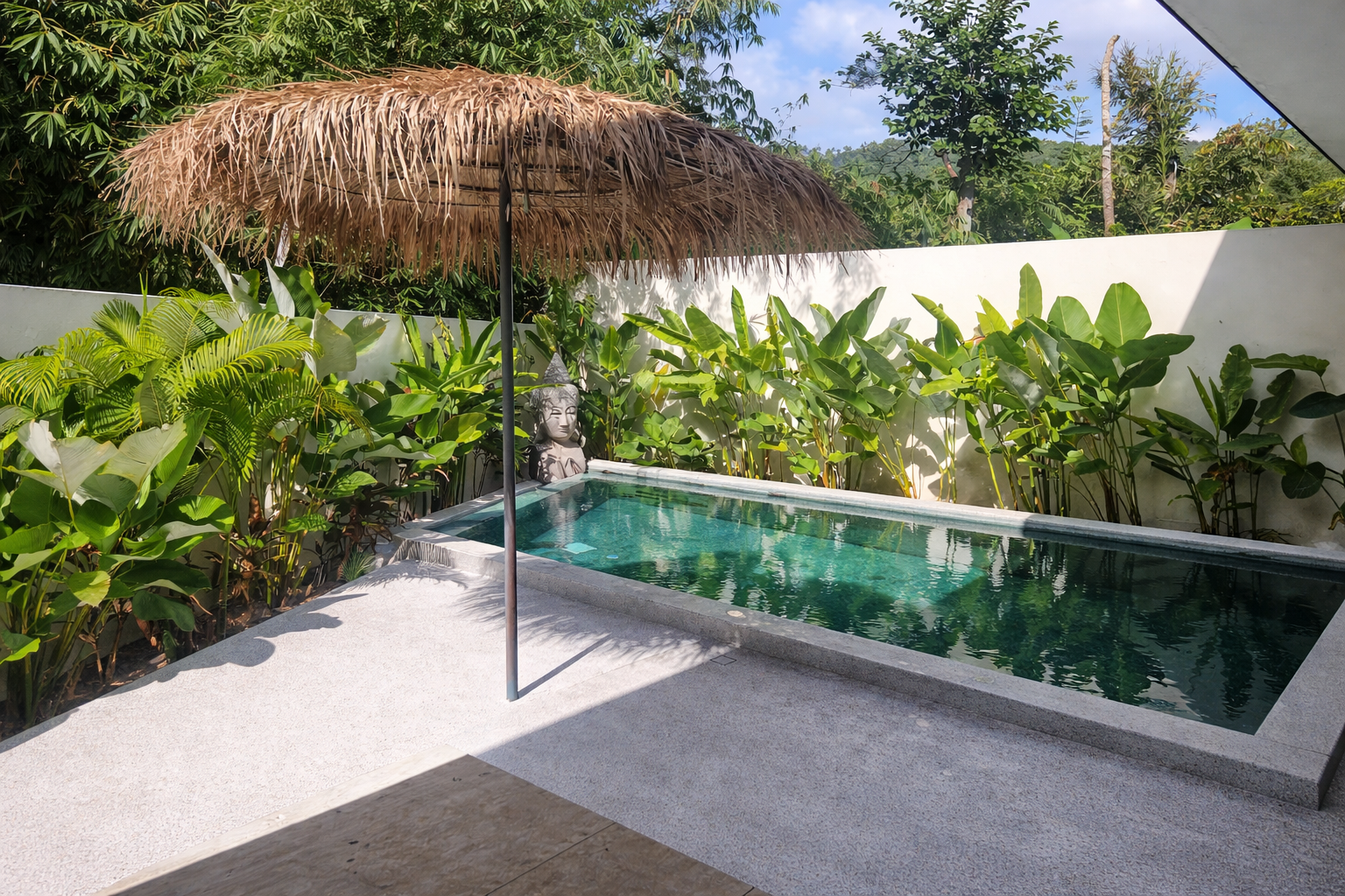 Private pool at Pool Villa Lamai surrounded by tropical plants and Buddha statue, Lamai Koh Samui